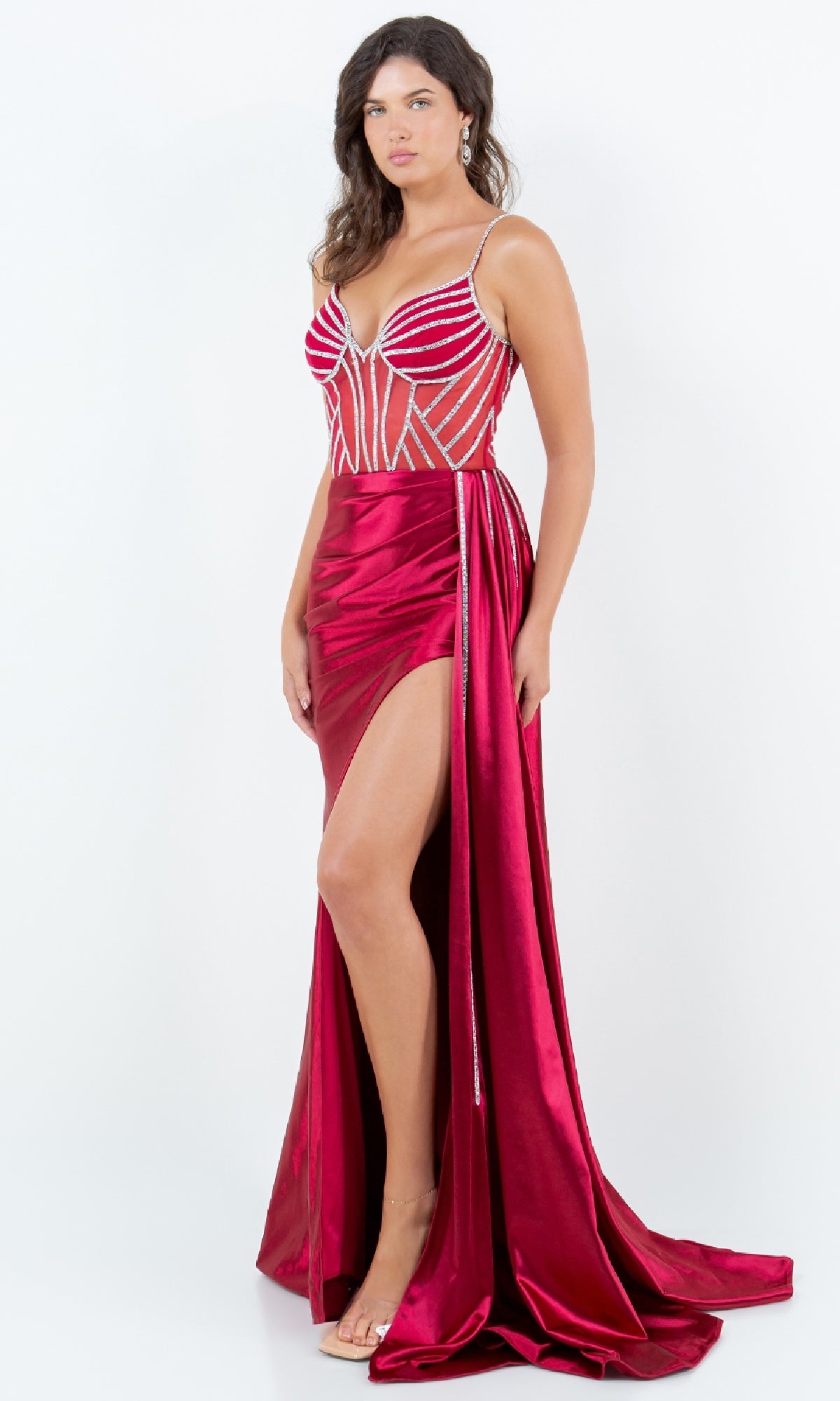 A woman models the Side-Sash Long Prom Gown (Cinderella Couture 8219J), a deep red sleeveless dress with beaded details, high slit, and train, posed against a plain white background.